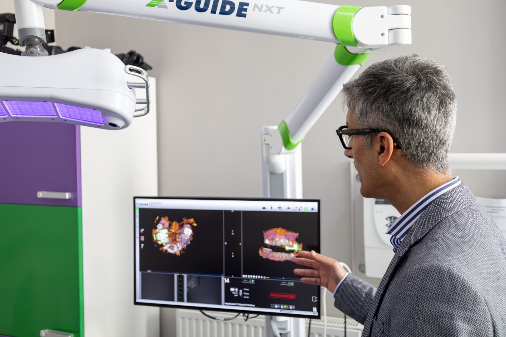 Dr Neeraj Puri reviewing a 3D digital implant plan on the X-Guide NXT navigation screen at Integrated Dentalcare, Edinburgh