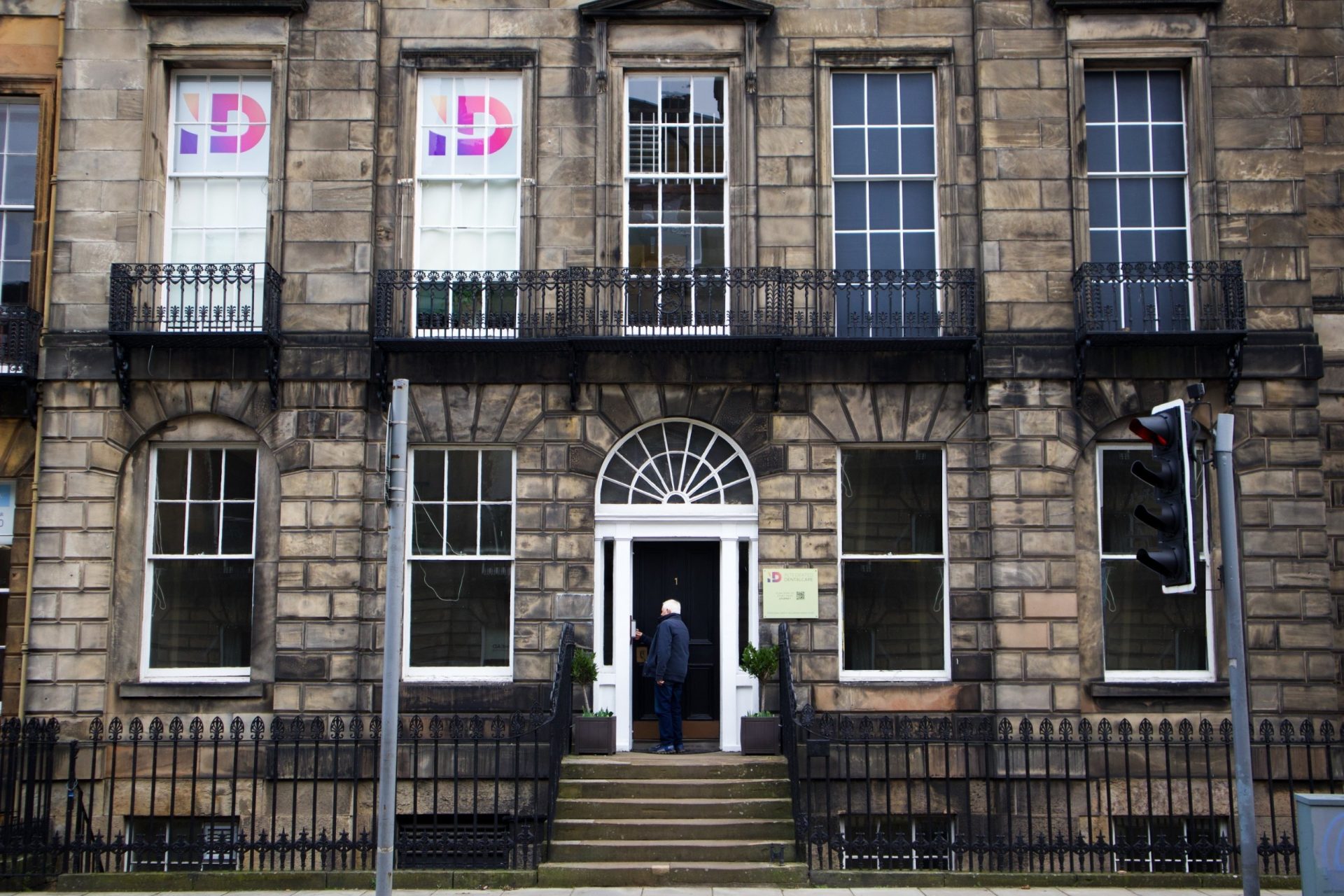 Georgian entrance of Integrated Dentalcare on Manor Place, Edinburgh, with black front door and IDC logo in the upper windows