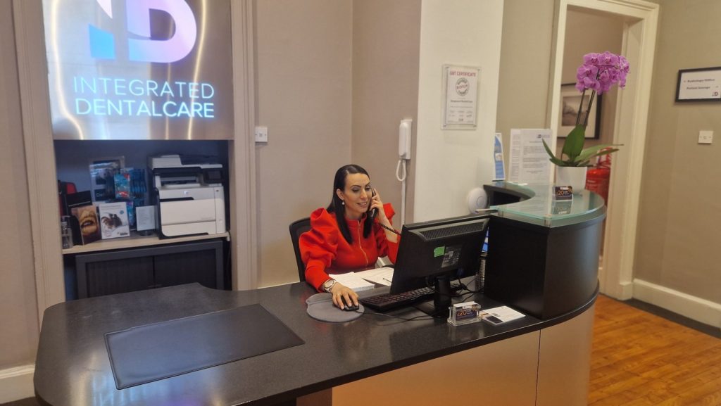 Sofia answering the phone at the Integrated Dentalcare reception desk on Manor Place, Edinburgh